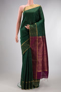 Pure Silk Bottle Green Raw Saree with Checked design on the body and Zari Border.  displayed on a mannequin