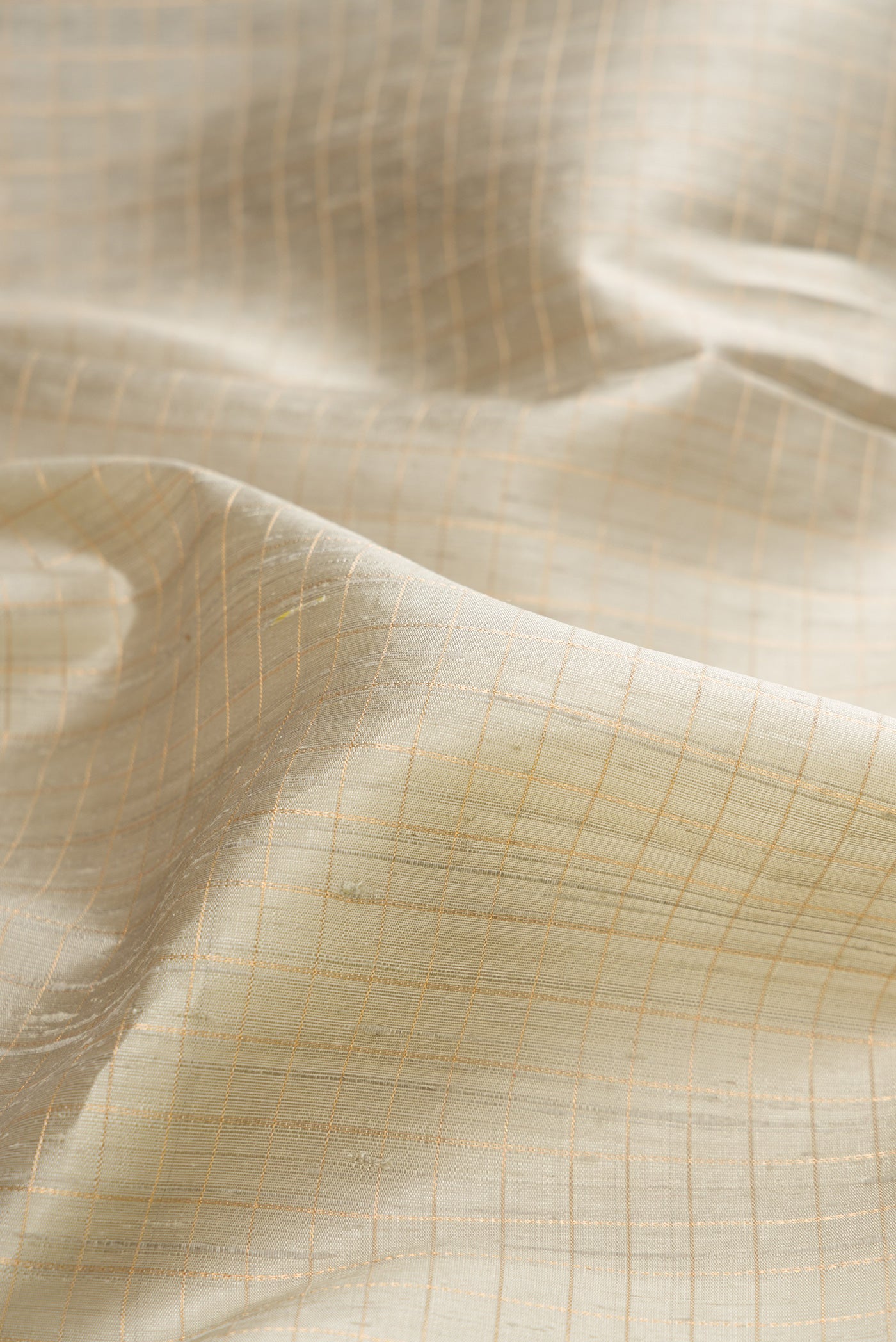 Close up of Pure Silk Grey Raw Saree with Checked design on the body and Fancy Border.  displaying folds