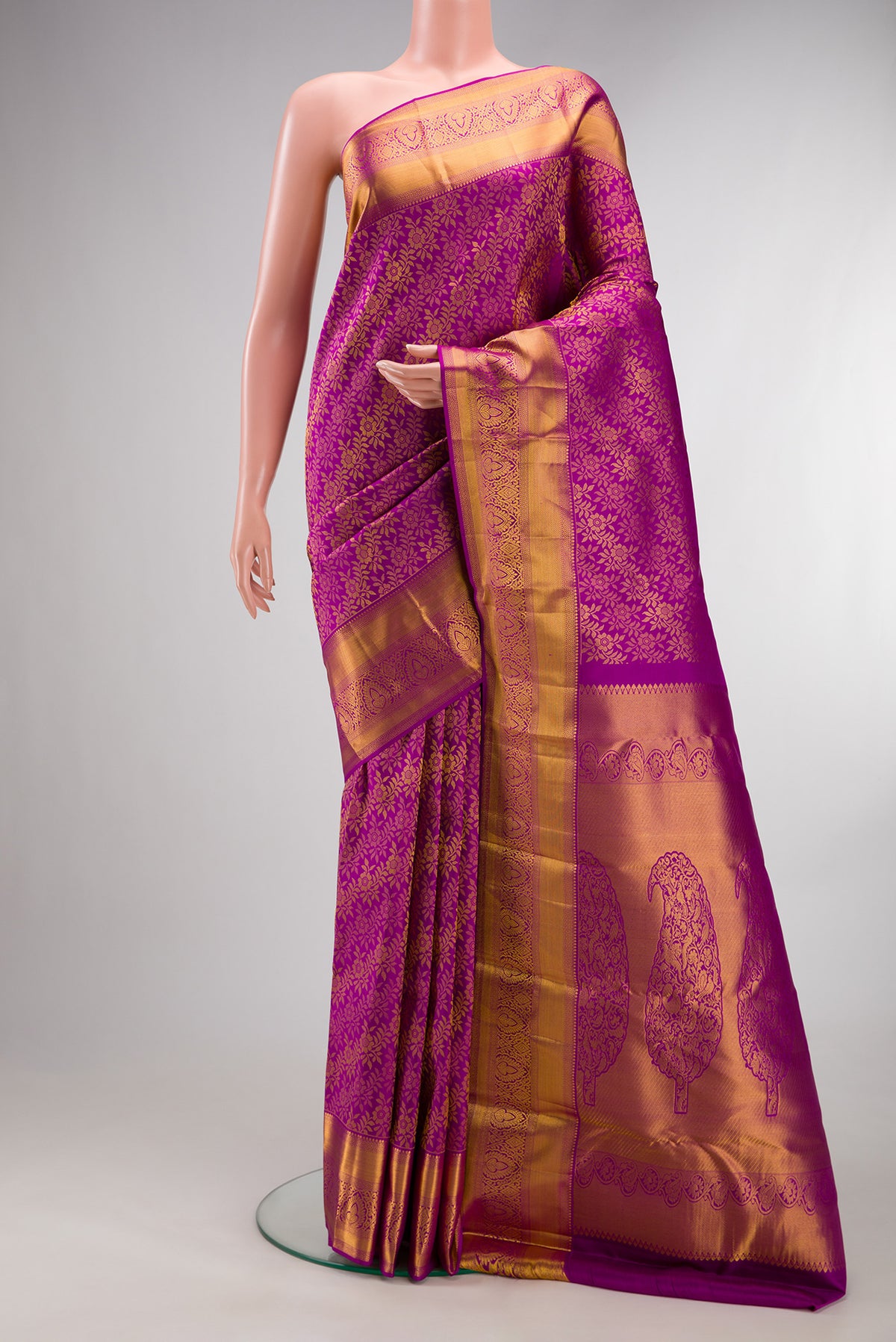 Pure Silk Magenta Kanchipuram Saree with Zari Brocade on the body and Zari Border.  displayed on a mannequin