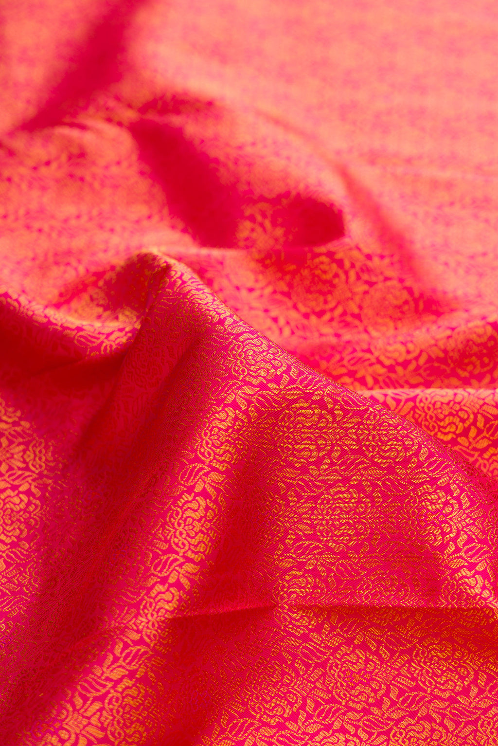 Close up of Pure Silk Dark Pink Dual Tone Kanchipuram Saree with Zari Brocade on the body and Zari Border.  displaying folds