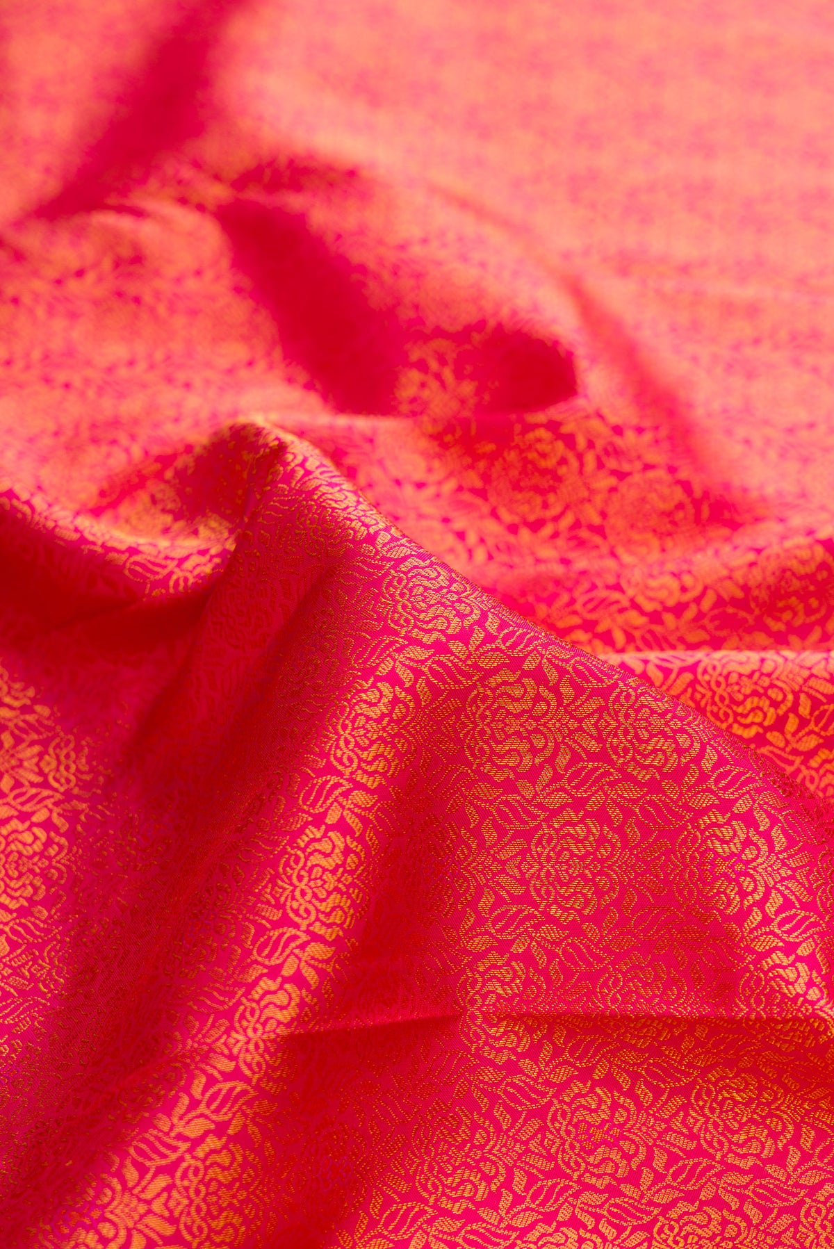 Close up of Pure Silk Dark Pink Dual Tone Kanchipuram Saree with Zari Brocade on the body and Zari Border.  displaying folds