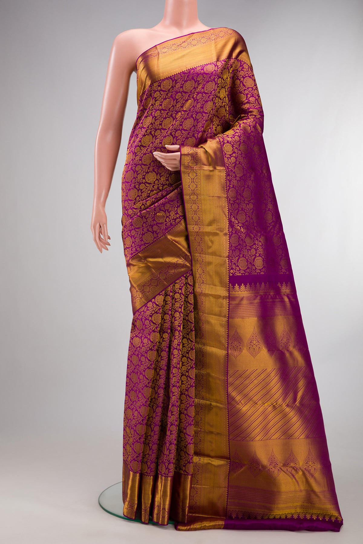 Pure Silk Magenta Kanchipuram Saree with Zari Brocade on the body and Zari Border.  displayed on a mannequin