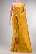 Pure Silk Gold Kanchipuram Saree with Zari Brocade on the body and Zari Border.  displayed on a mannequin