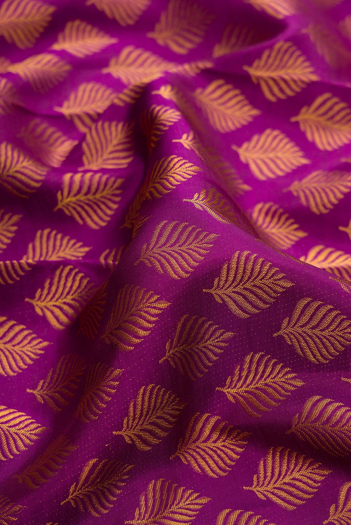 Close up of Pure Silk Purple Kanchipuram Saree with Zari Brocade on the body and Zari Border.  displaying folds