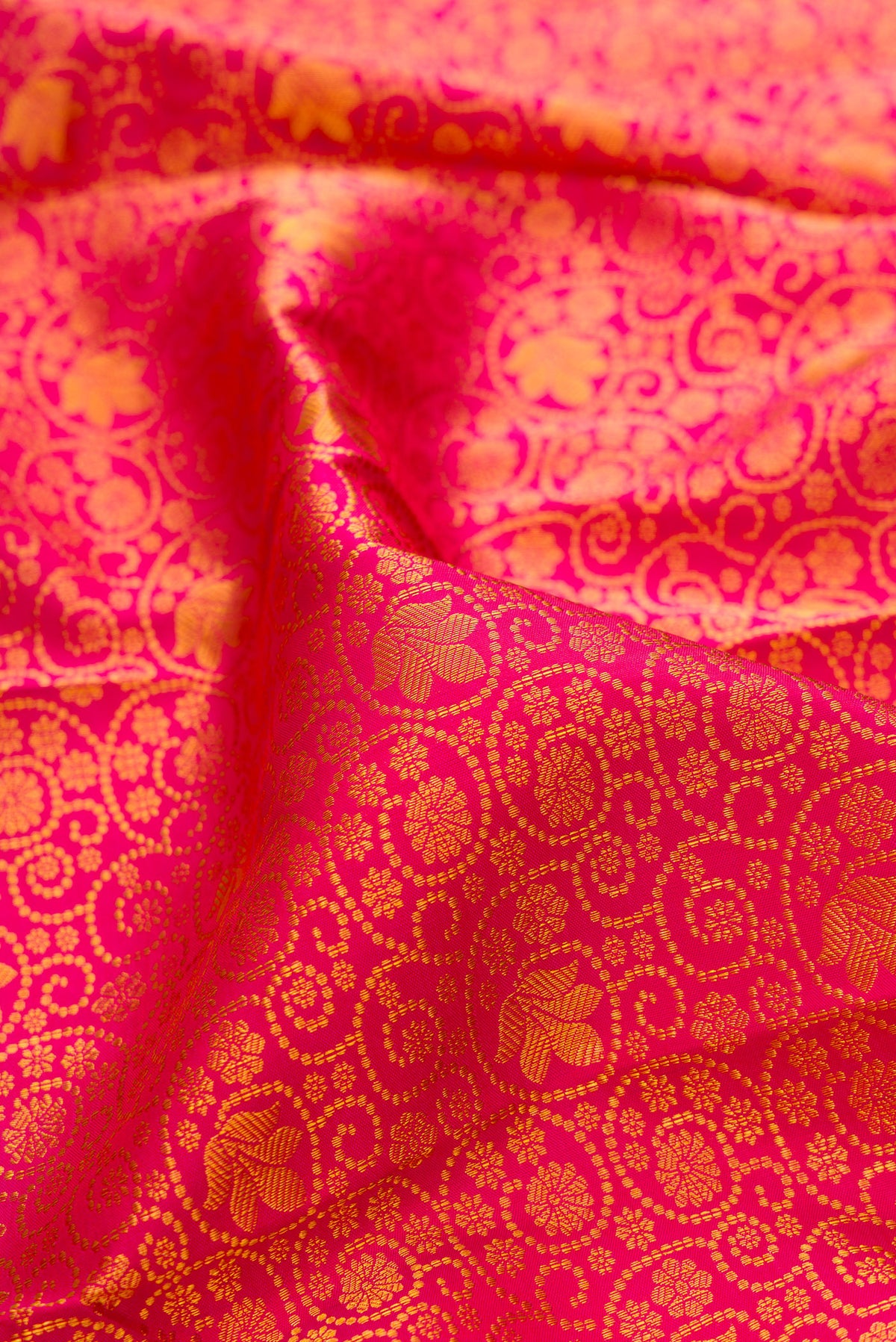 Close up of Pure Silk Pink Kanchipuram Saree with Zari Brocade on the body and Zari Border.  displaying folds