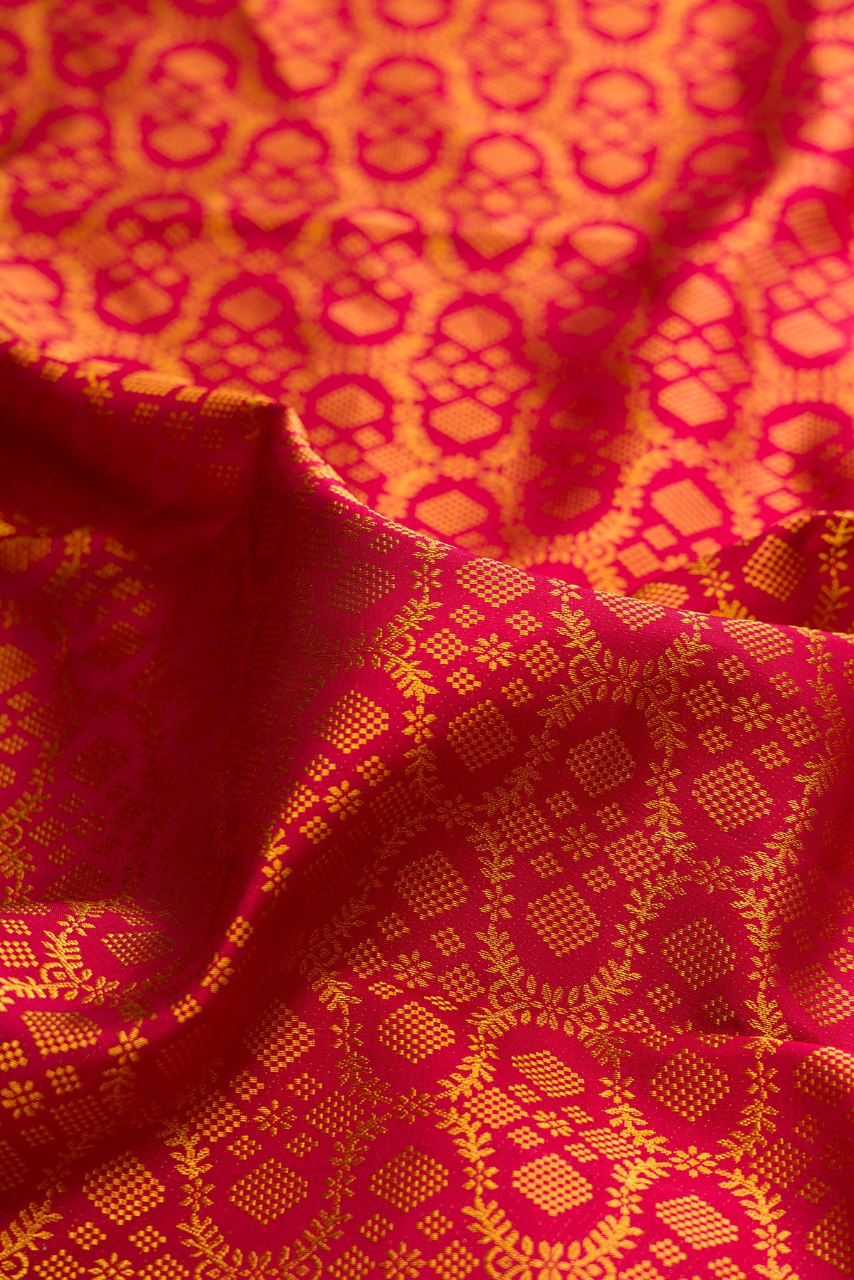 Close up of Pure Silk Red Kanchipuram Saree with Zari Brocade on the body and Zari Border.  displaying folds