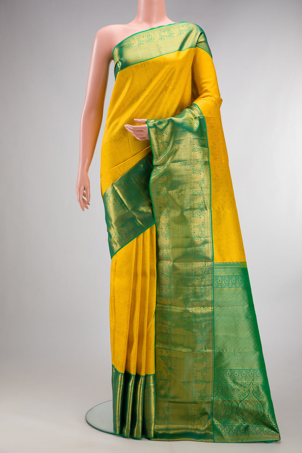 Pure Silk Yellow Kanjivaram Saree with Zari Brocade on the body and Zari Border.  displayed on a mannequin