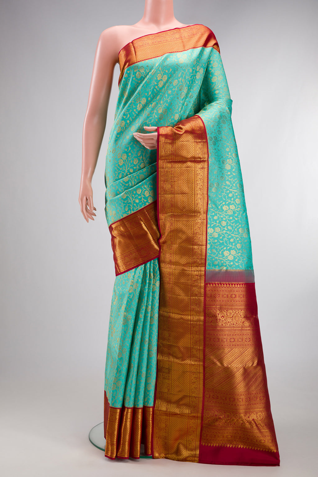 Turquoise Kanjivaram Silk Saree with Zari Brocade on the body and Zari Border.  displayed on a mannequin