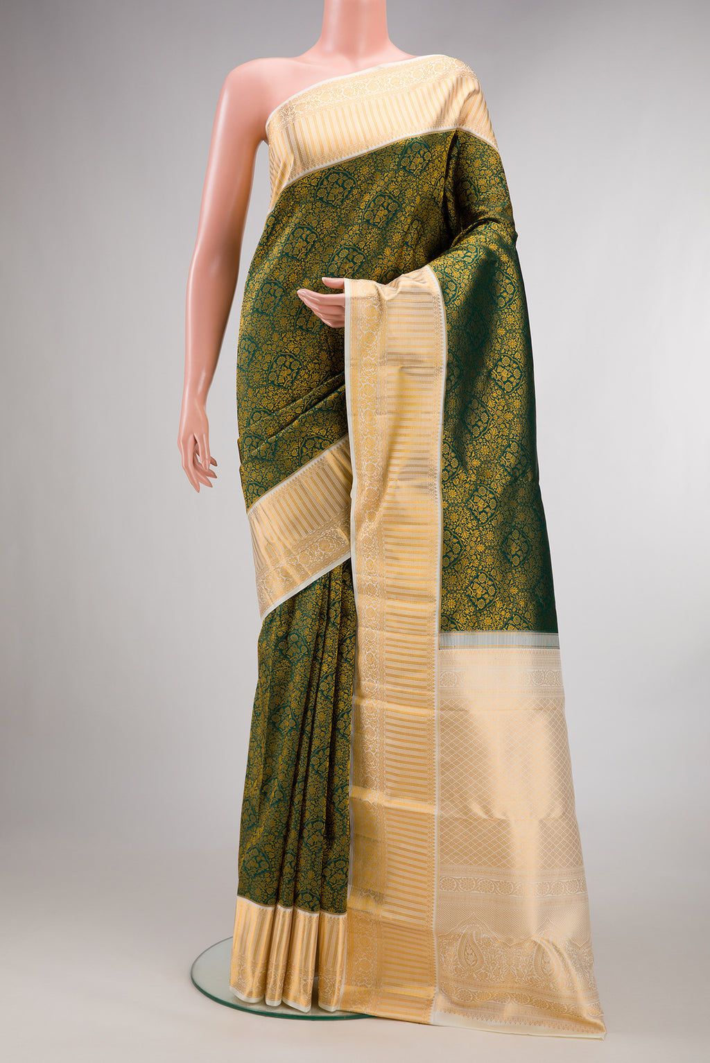 Pure Silk Bottle Green Kanjivaram Saree with Zari Brocade on the body and Zari Border.  displayed on a mannequin