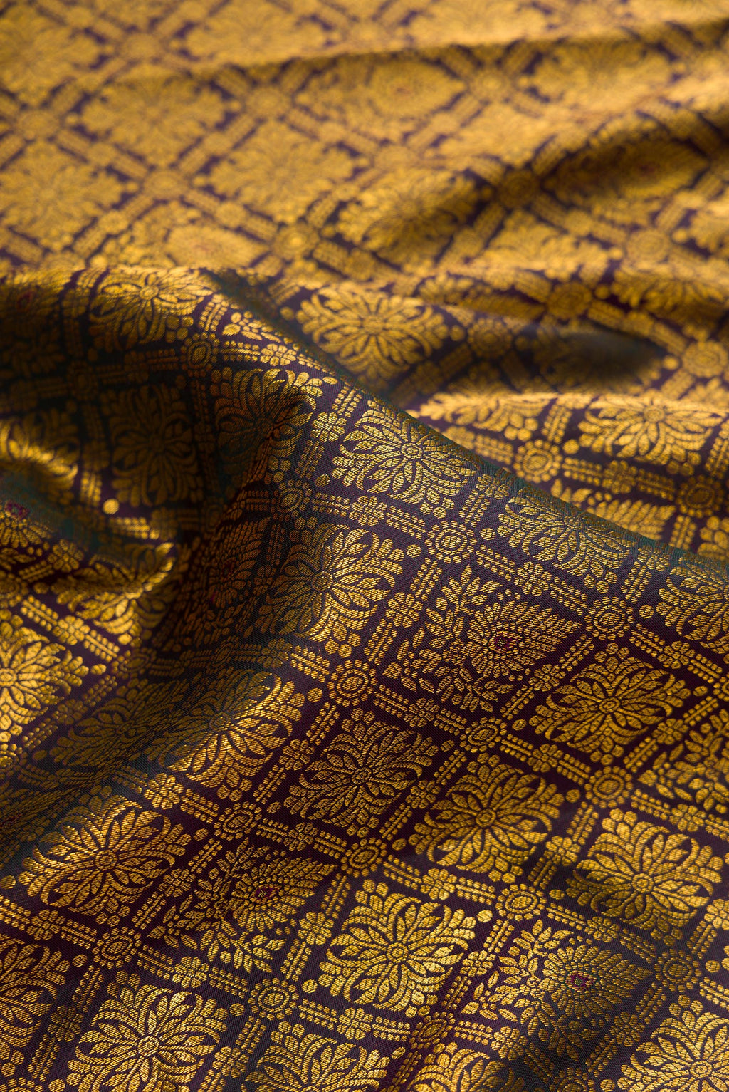 Close up of Pure Silk Bottle Green Dual Tone Kanjivaram Saree with Zari Brocade on the body and Zari Border.  displaying folds