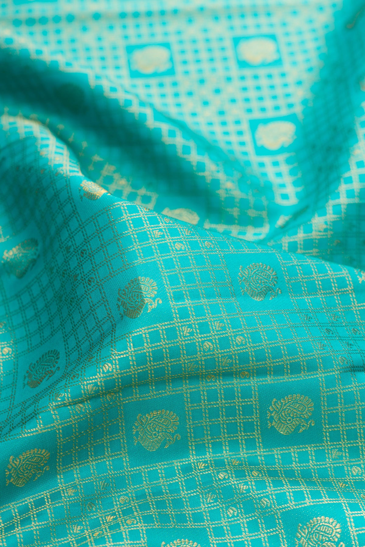 Close up of Pure Silk Turquoise Kanjivaram Saree with Zari Brocade on the body and Zari Border.  displaying folds