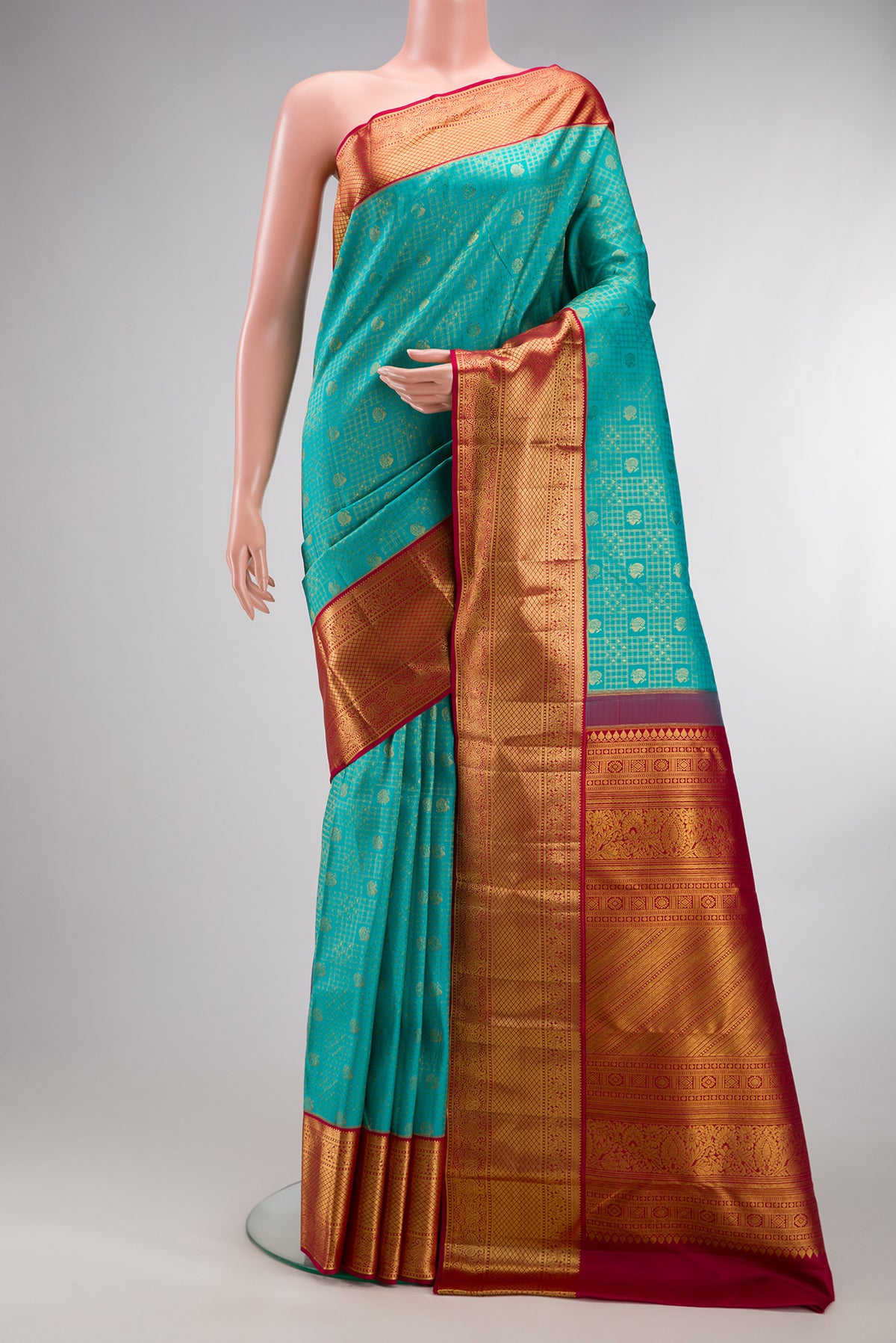 Pure Silk Turquoise Kanjivaram Saree with Zari Brocade on the body and Zari Border.  displayed on a mannequin