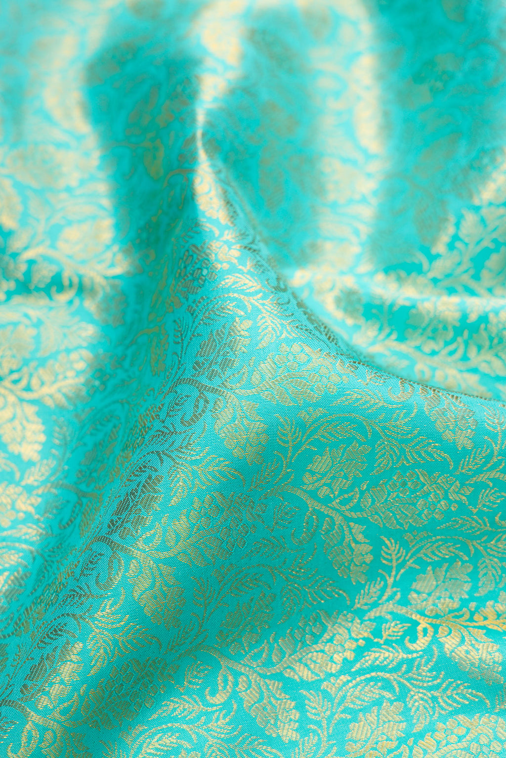 Close up of Pure Silk Turquoise Kanjivaram Saree with Zari Brocade on the body and Zari Border.  displaying folds