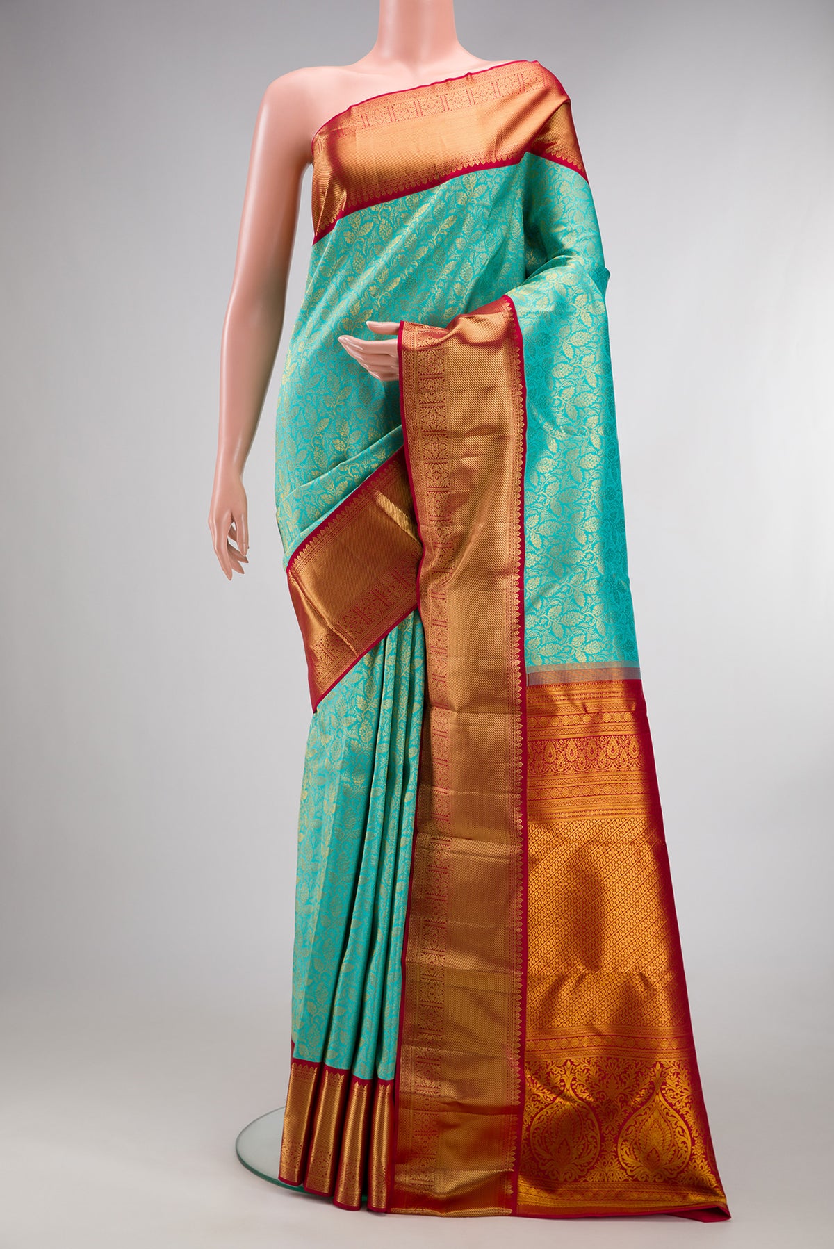 Pure Silk Turquoise Kanjivaram Saree with Zari Brocade on the body and Zari Border.  displayed on a mannequin