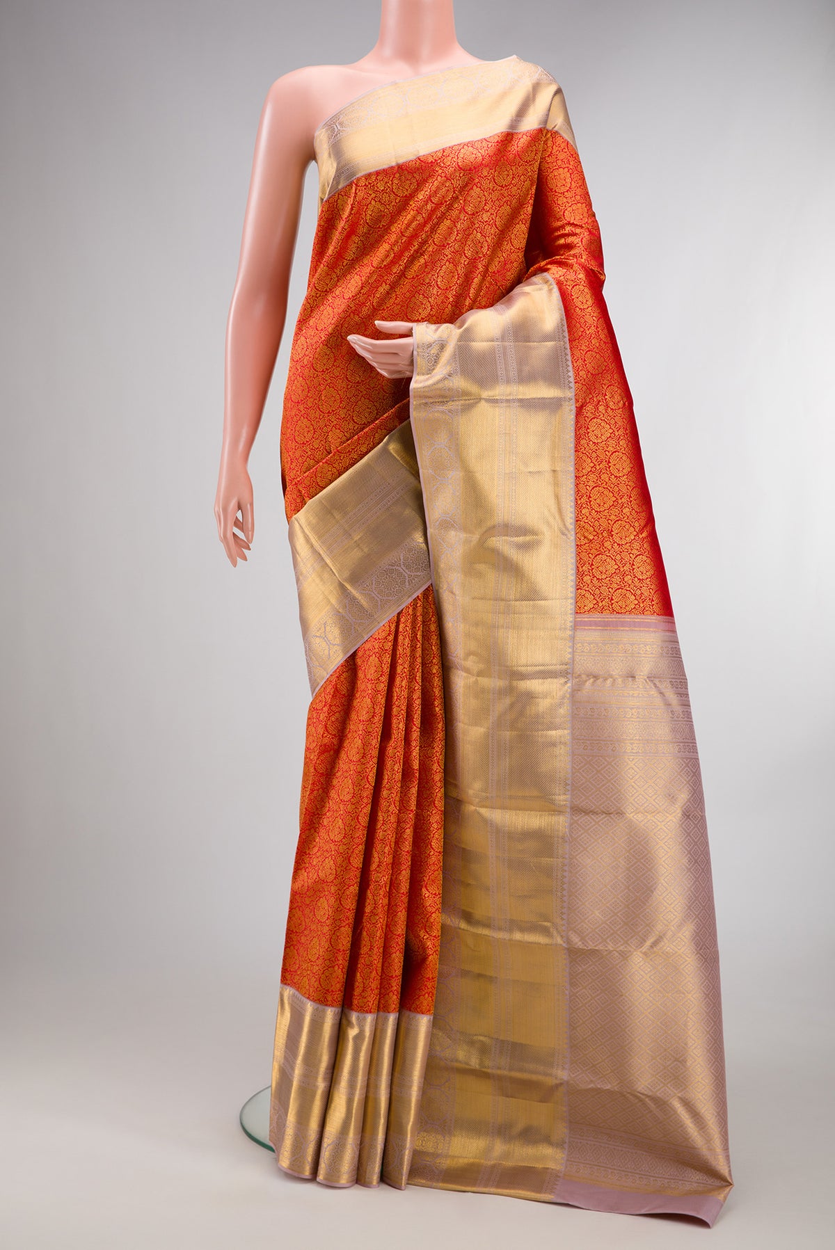 Pure Silk Red Kanjivaram Saree with Zari Brocade on the body and Zari Border.  displayed on a mannequin