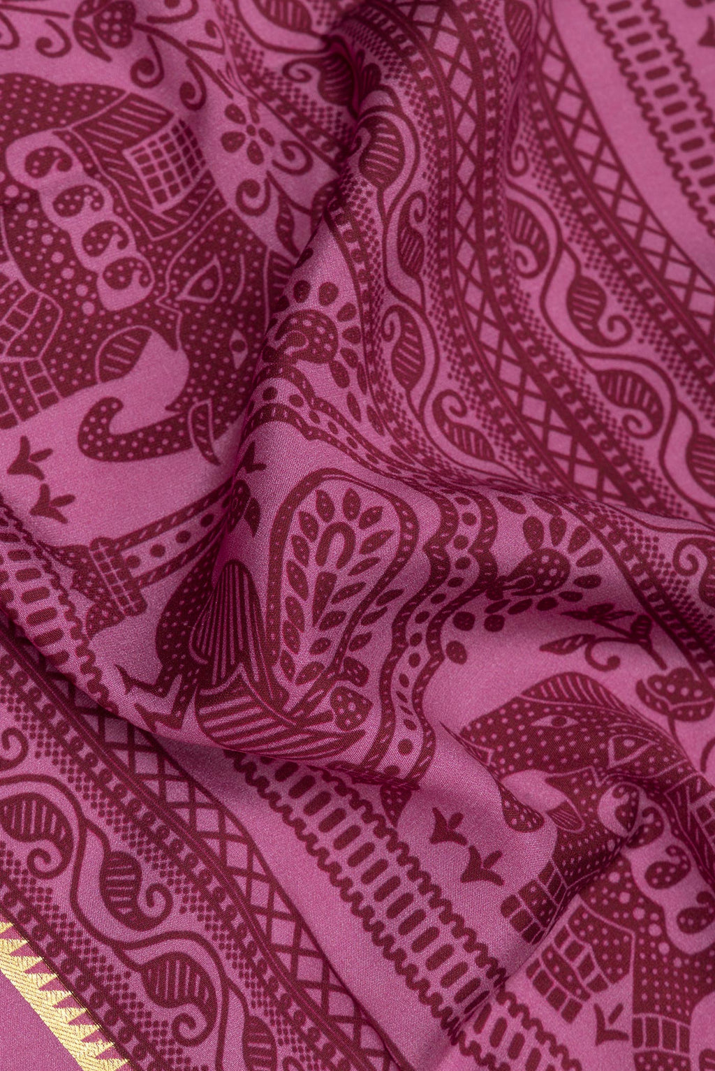 Close up of Light Magenta Mysore Crepe Saree with Printed design on the body and Zari Border.  displaying folds