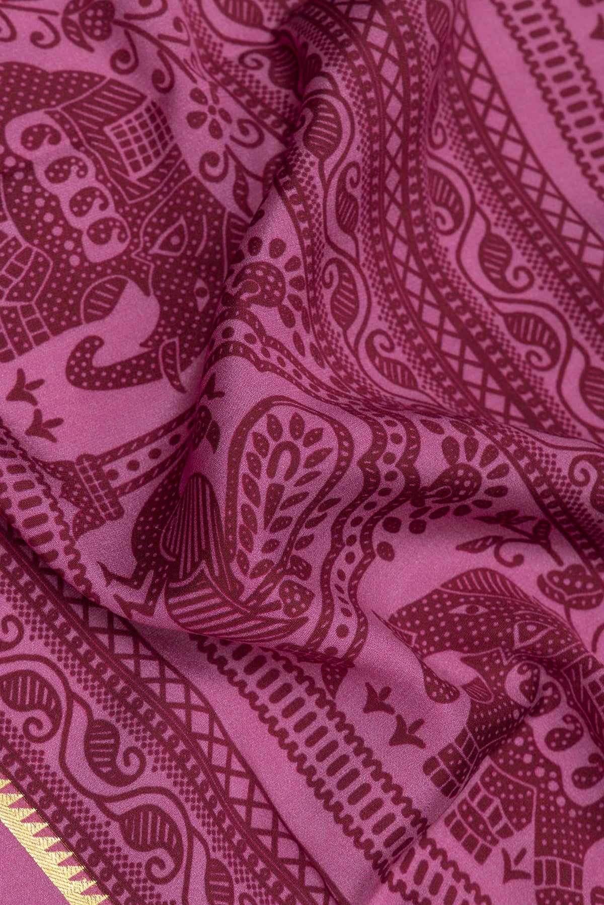 Close up of Light Magenta Mysore Crepe Saree with Printed design on the body and Zari Border.  displaying folds