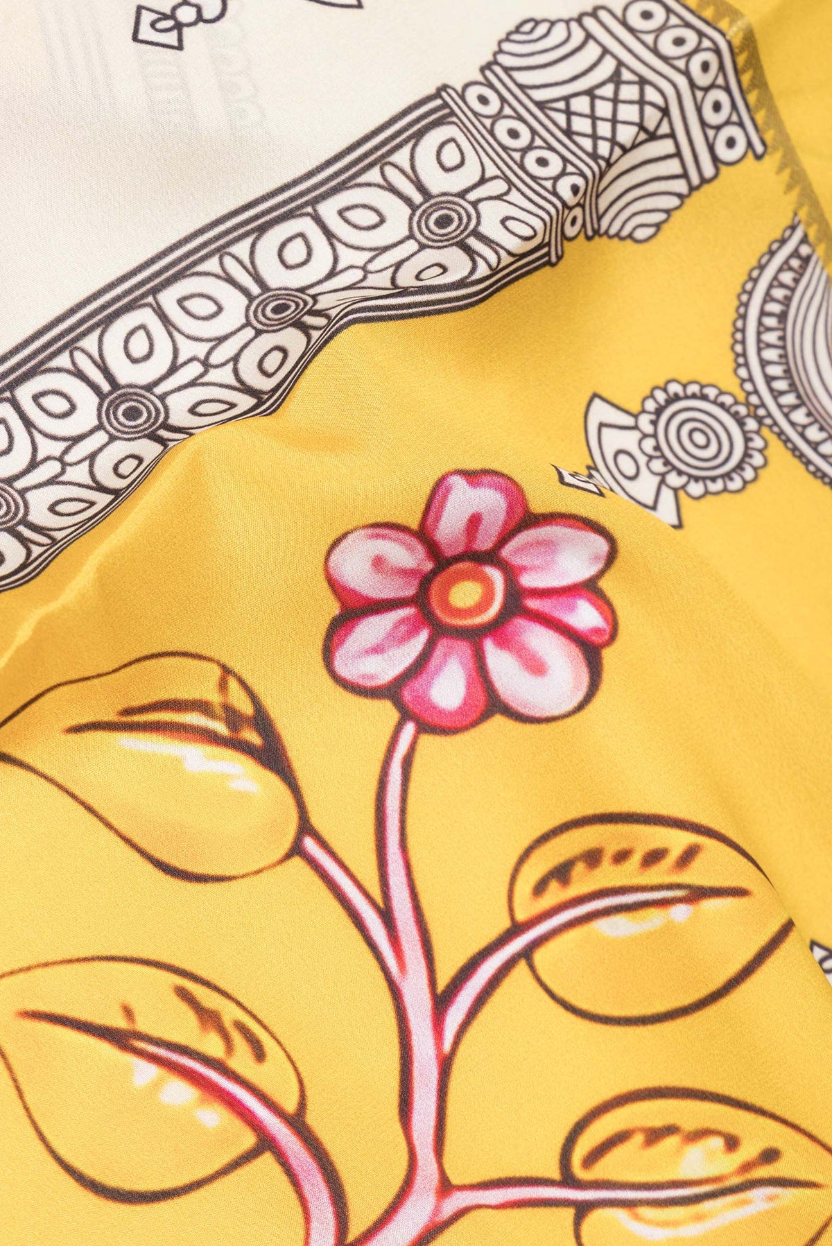 Close up of Lemon Yellow Mysore Crepe Saree with Printed design on the body and Zari Border.  displaying folds