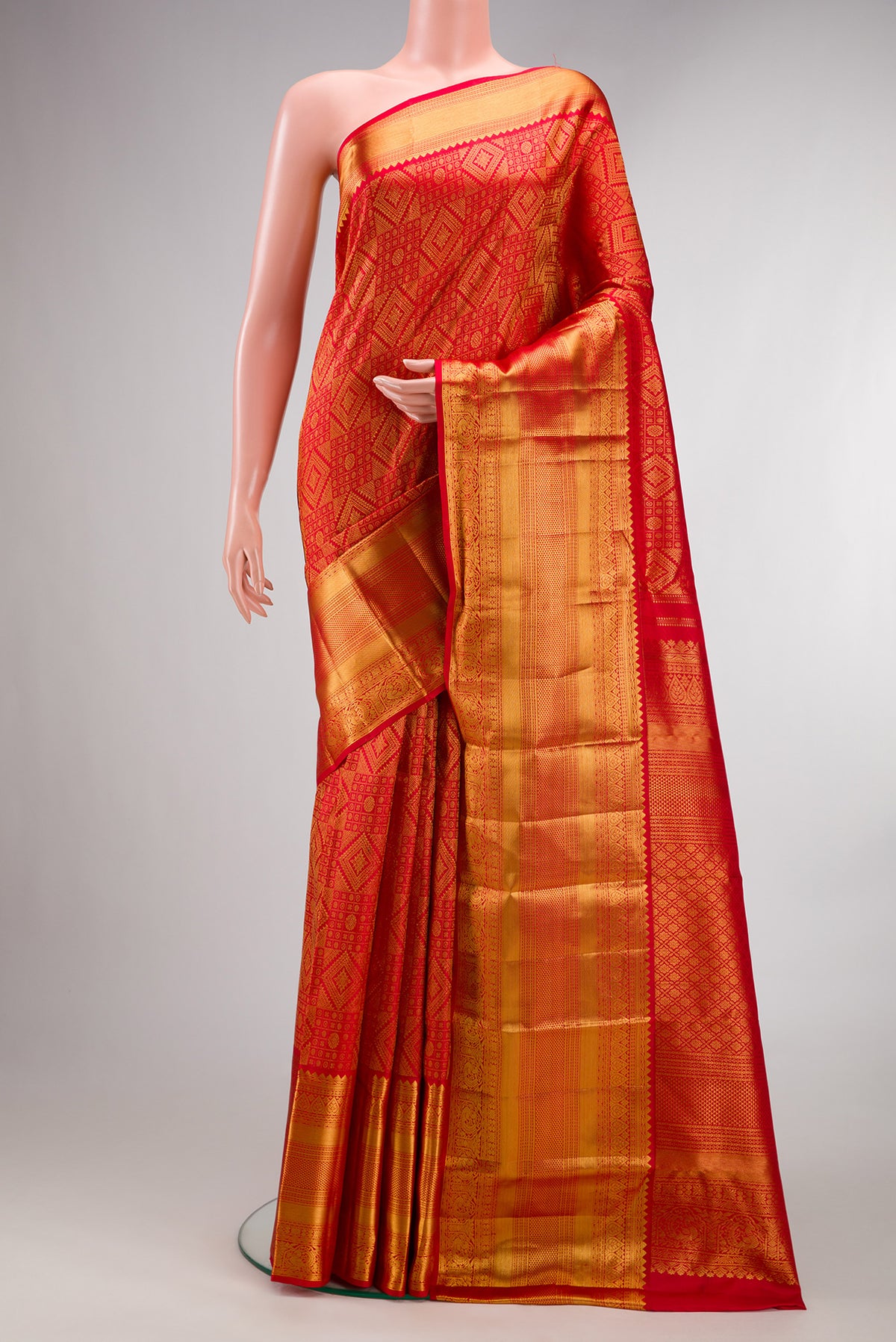 Pure Silk Red Kanchipuram Saree with Zari Brocade on the body and Zari Border.  displayed on a mannequin