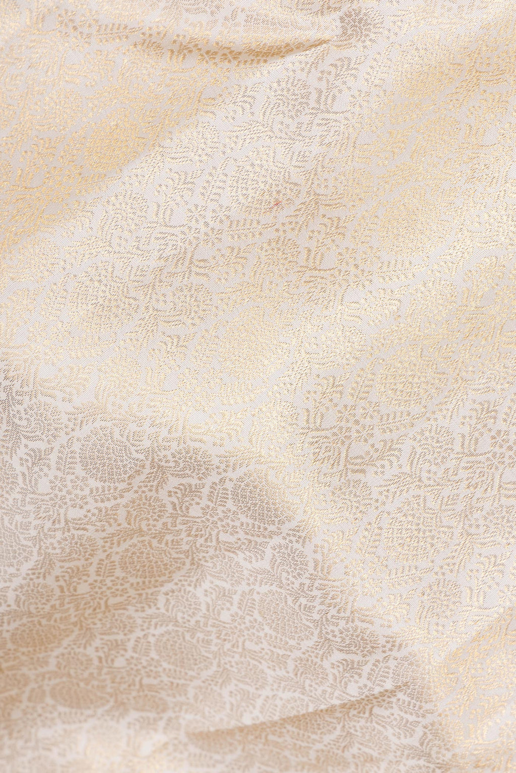 Close up of Pure Silk Off White Kanchipuram Saree with Zari Brocade on the body and Zari Border.  displaying folds