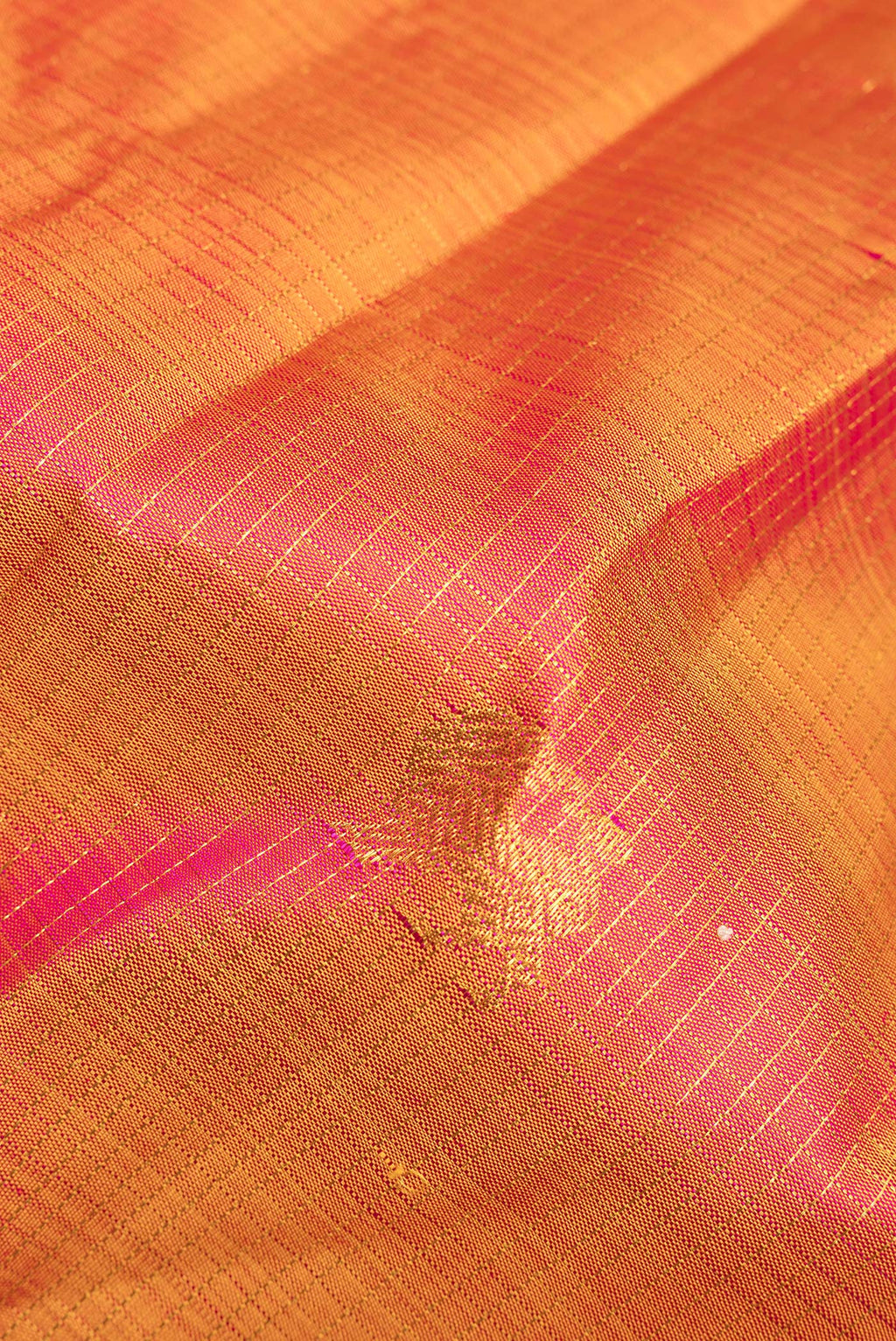 Close up of Pure Silk Mustard Dual Tone Kanjivaram Saree with Checked design on the body and Zari Border.  displaying folds