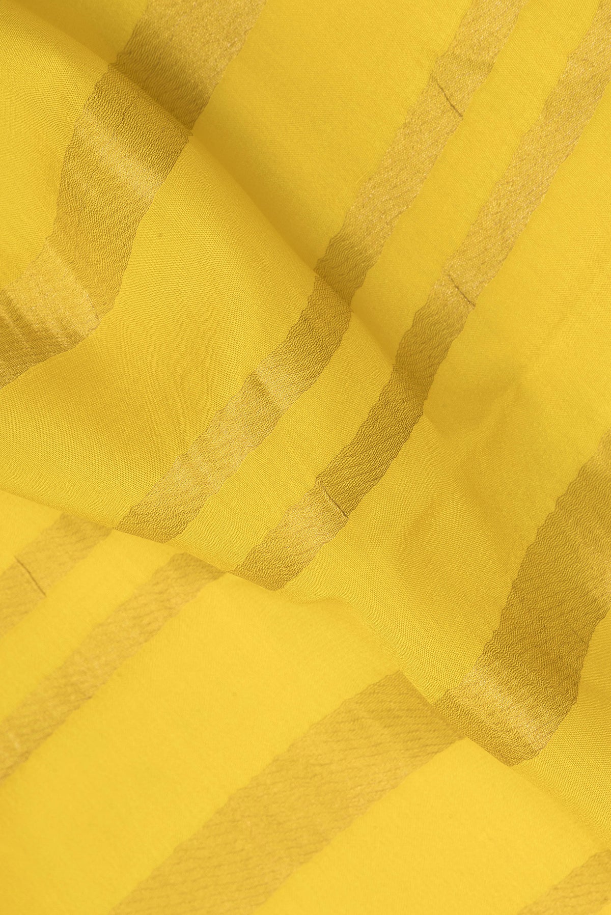 Close up of Lemon Yellow Mysore Crepe Saree with Stripes on the body and Zari Border.  displaying folds
