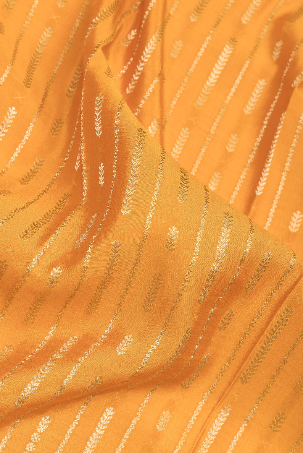 Close up of Mustard Mysore Crepe Saree with Stripes on the body and Zari Border.  displaying folds