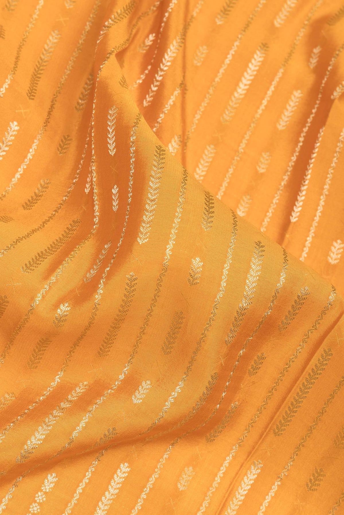Close up of Mustard Mysore Crepe Saree with Stripes on the body and Zari Border.  displaying folds