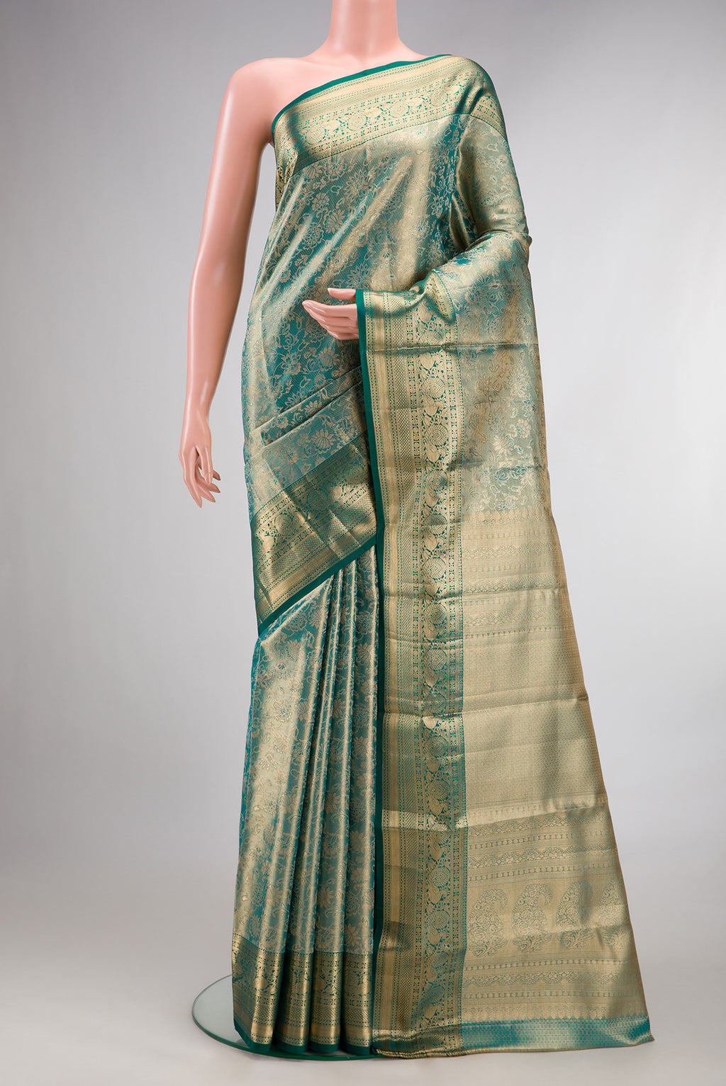 Sea Green Dual Tone Kanchipuram Tissue Saree with Zari Brocade on the body and Zari Border.  displayed on a mannequin