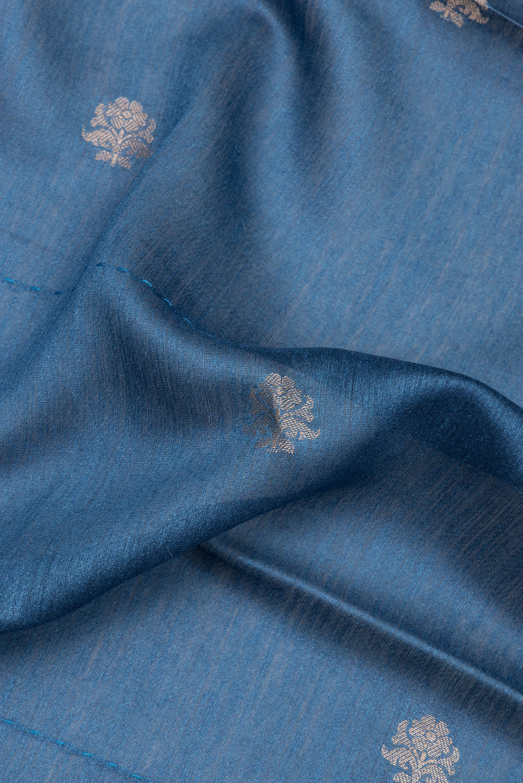 Close up of Blue Tussar Saree with Zari Butta on the body and Embroidered Border.  displaying folds