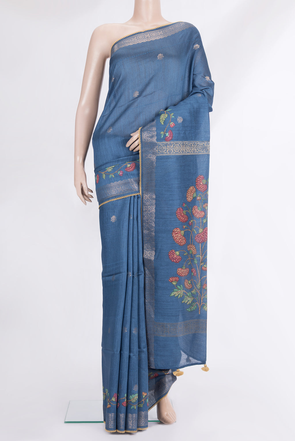 Blue Tussar Saree with Zari Butta on the body and Embroidered Border.  displayed on a mannequin