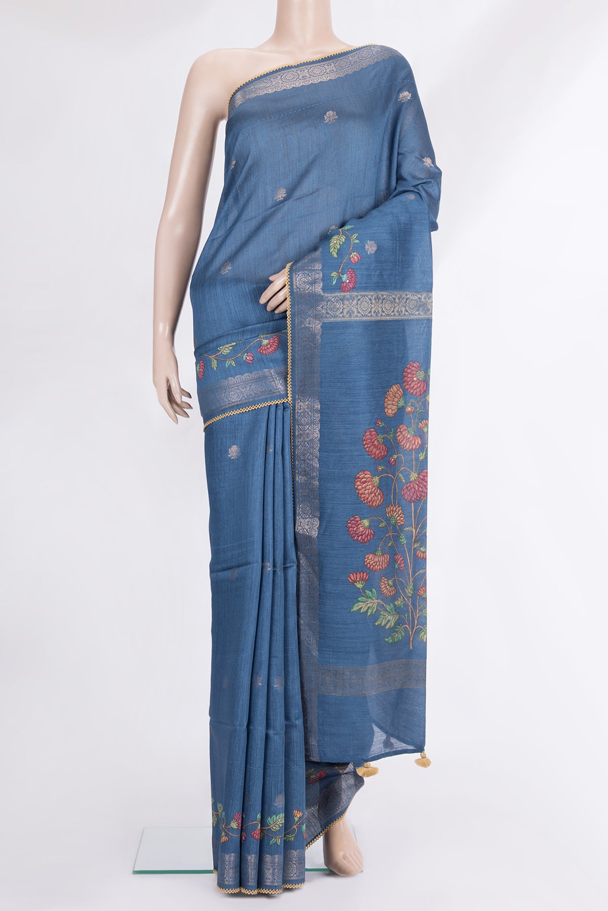 Blue Tussar Saree with Zari Butta on the body and Embroidered Border.  displayed on a mannequin