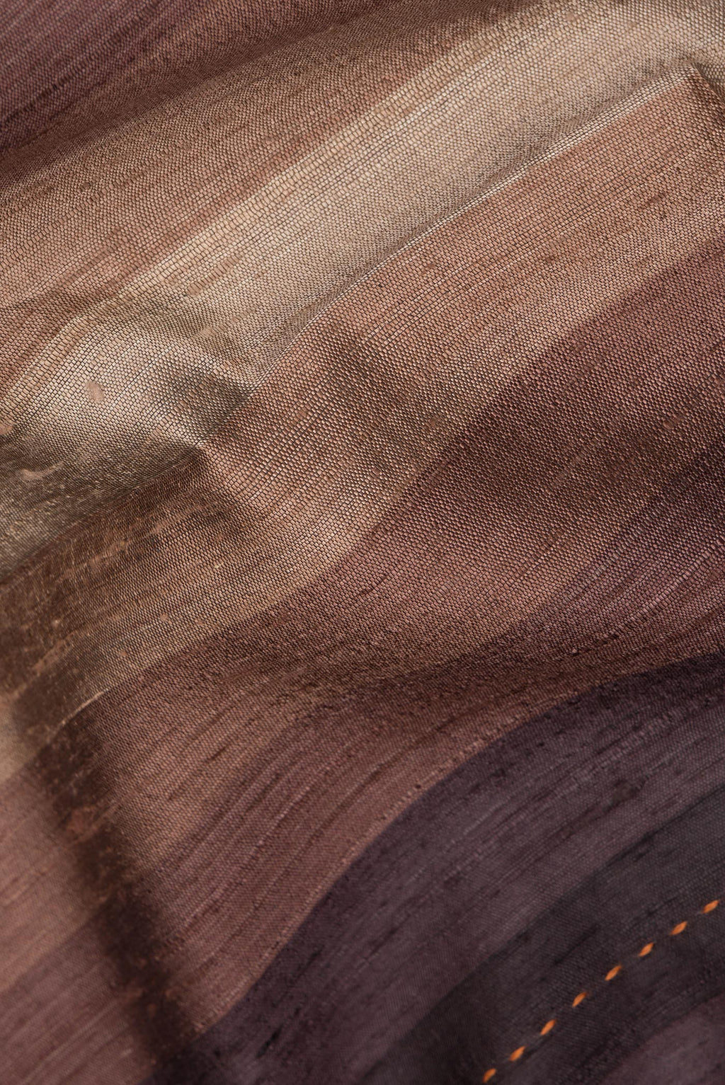 Close up of Pure Silk Brown Dual Tone Tussar Saree with Stripes on the body and Embroidery Border.  displaying folds