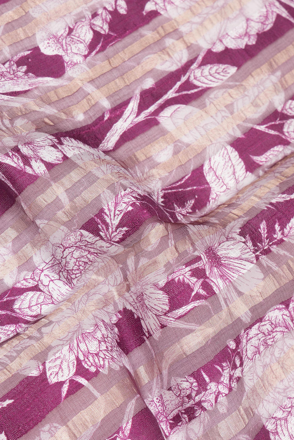 Close up of Pure Silk Magenta Dual Tone Tussar Saree with Printed design on the body and Fancy Border.  displaying folds