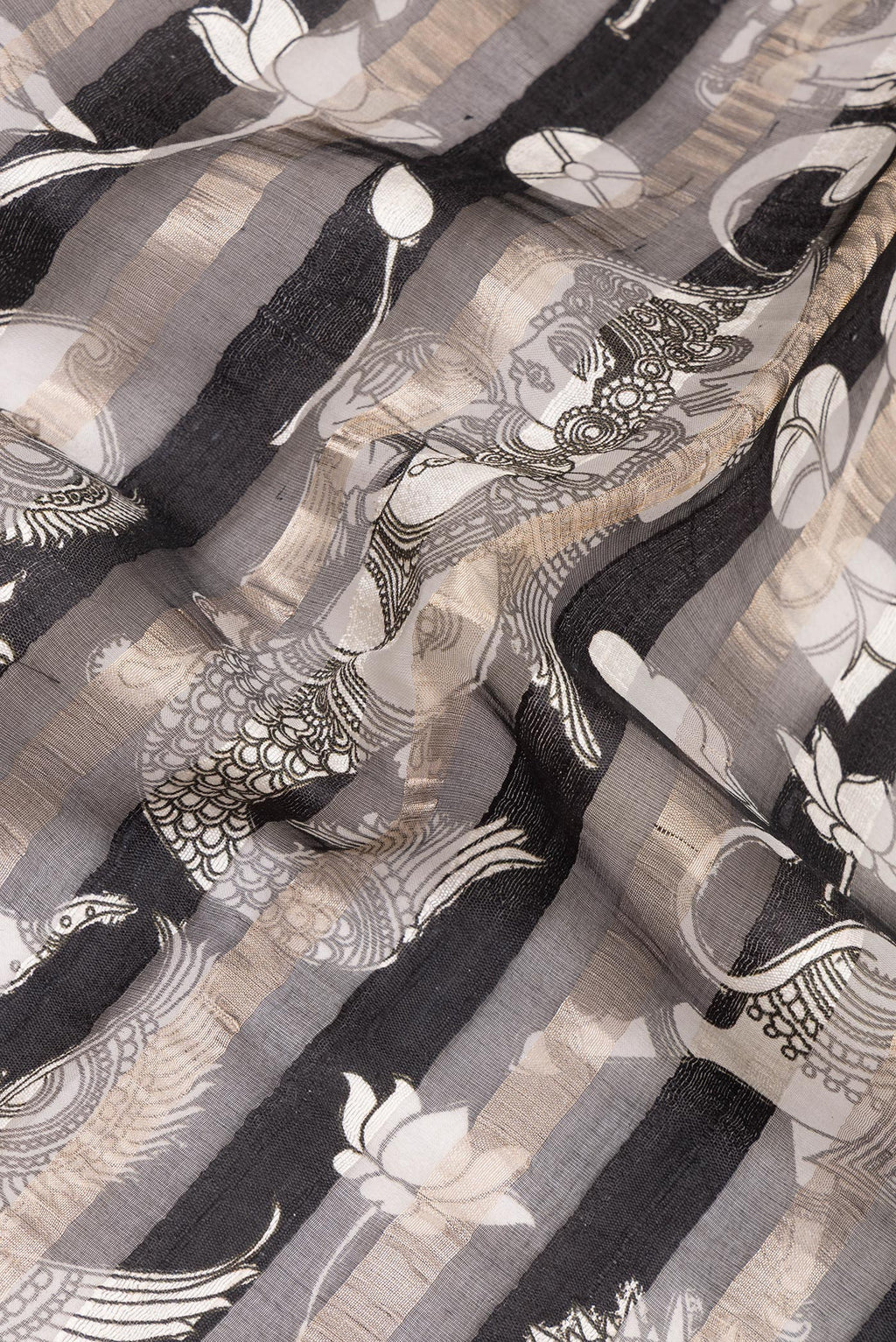 Close up of Black Tussar Saree with Printed design on the body and Embroidered Border.  displaying folds