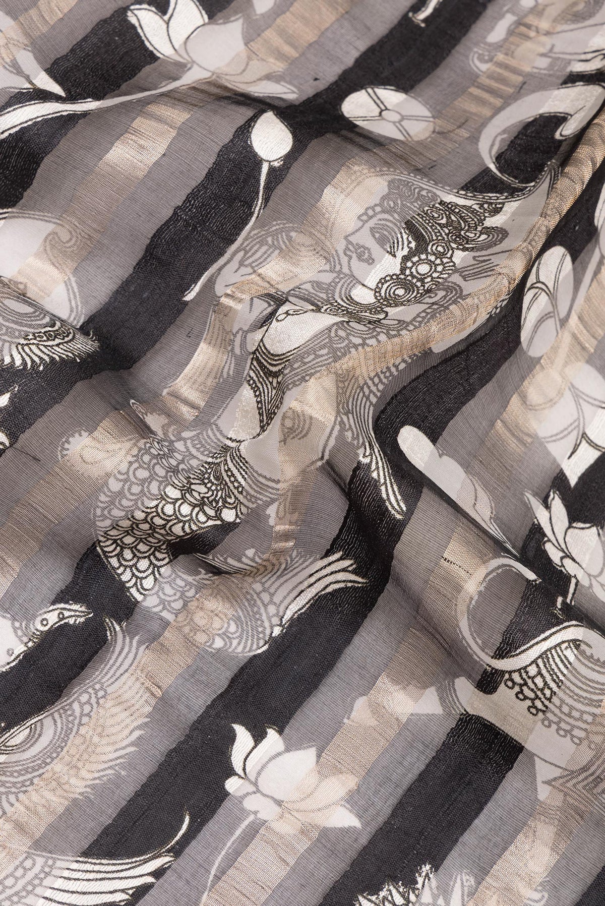 Close up of Black Tussar Saree with Printed design on the body and Embroidered Border.  displaying folds