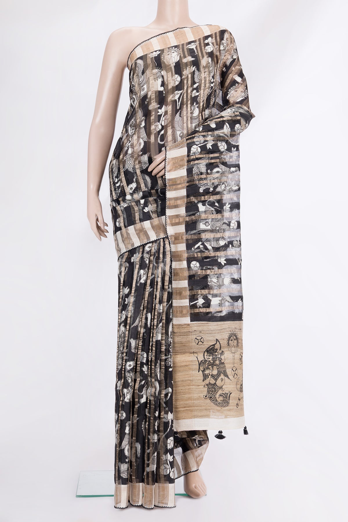 Black Tussar Saree with Printed design on the body and Embroidered Border.  displayed on a mannequin