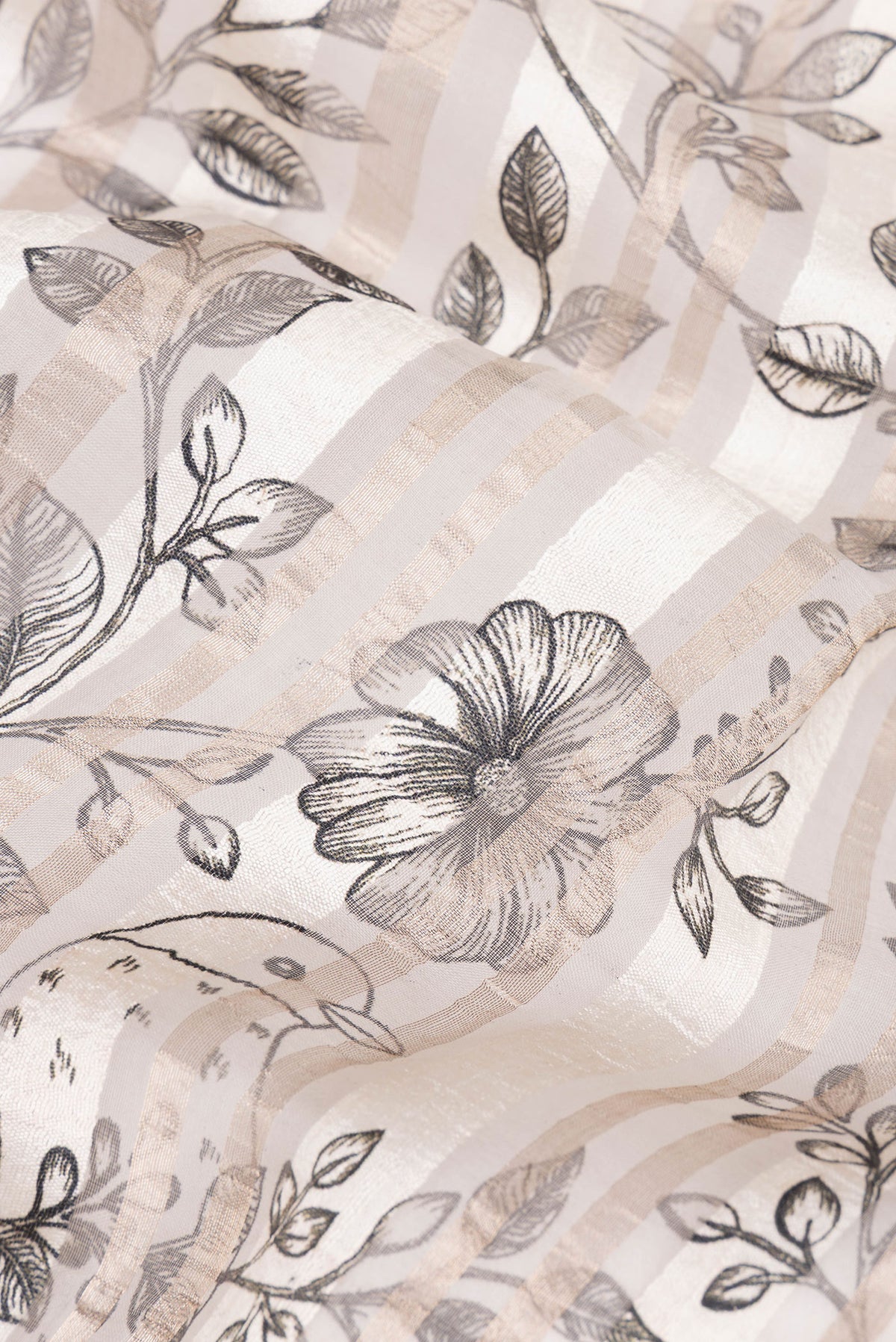 Close up of Pure Silk Off White Dual Tone Tussar Saree with Printed design on the body and Fancy Border.  displaying folds
