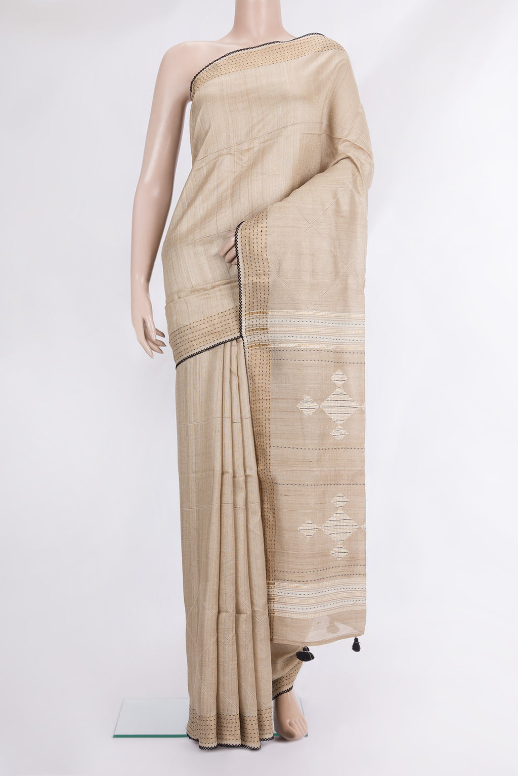 Beige Tussar Saree with Embroidered on the body and Embroidered Border.  displayed on a mannequin