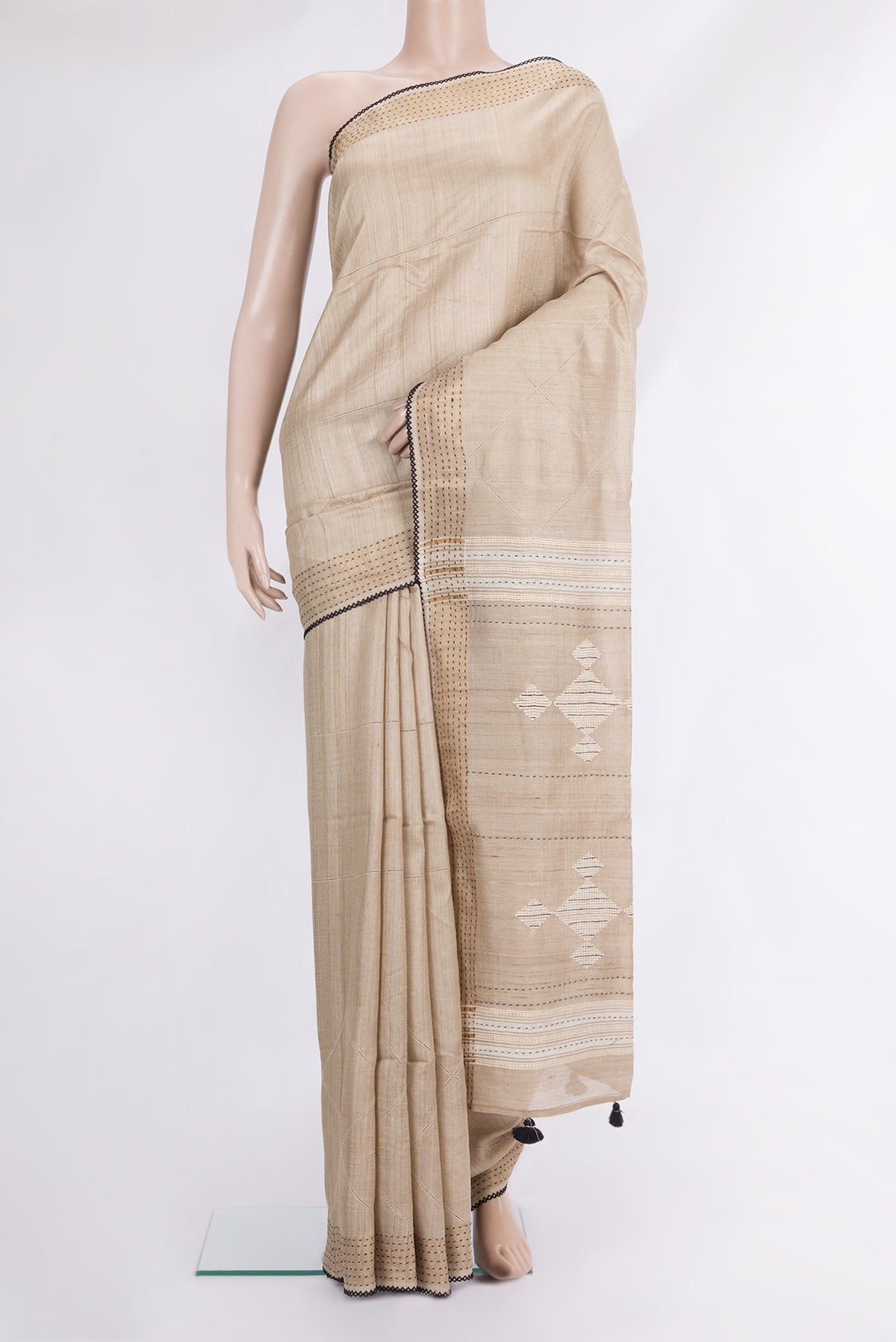Beige Tussar Saree with Embroidered on the body and Embroidered Border.  displayed on a mannequin