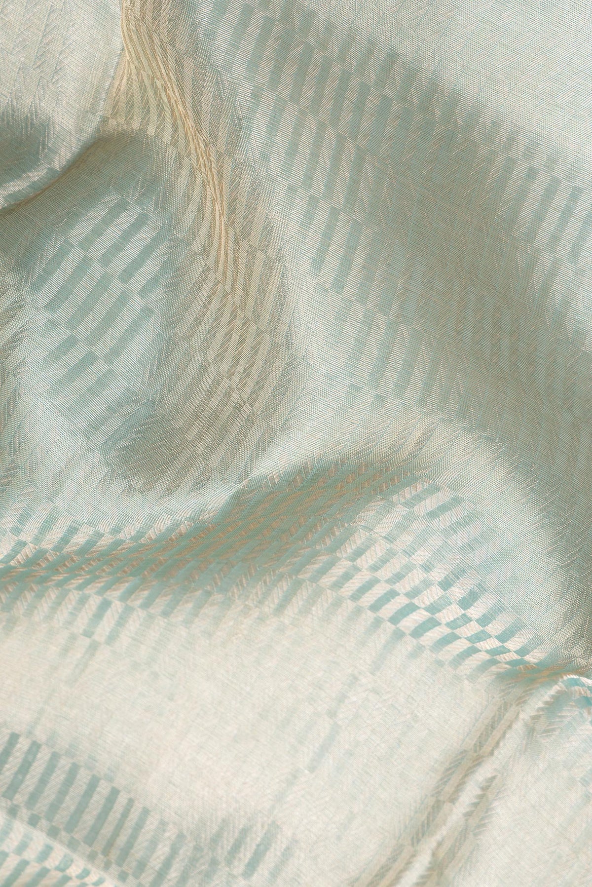 Close up of Pure Silk Sky Blue Dual Tone Banarasi Saree with Zari Brocade on the body and Zari Border.  displaying folds