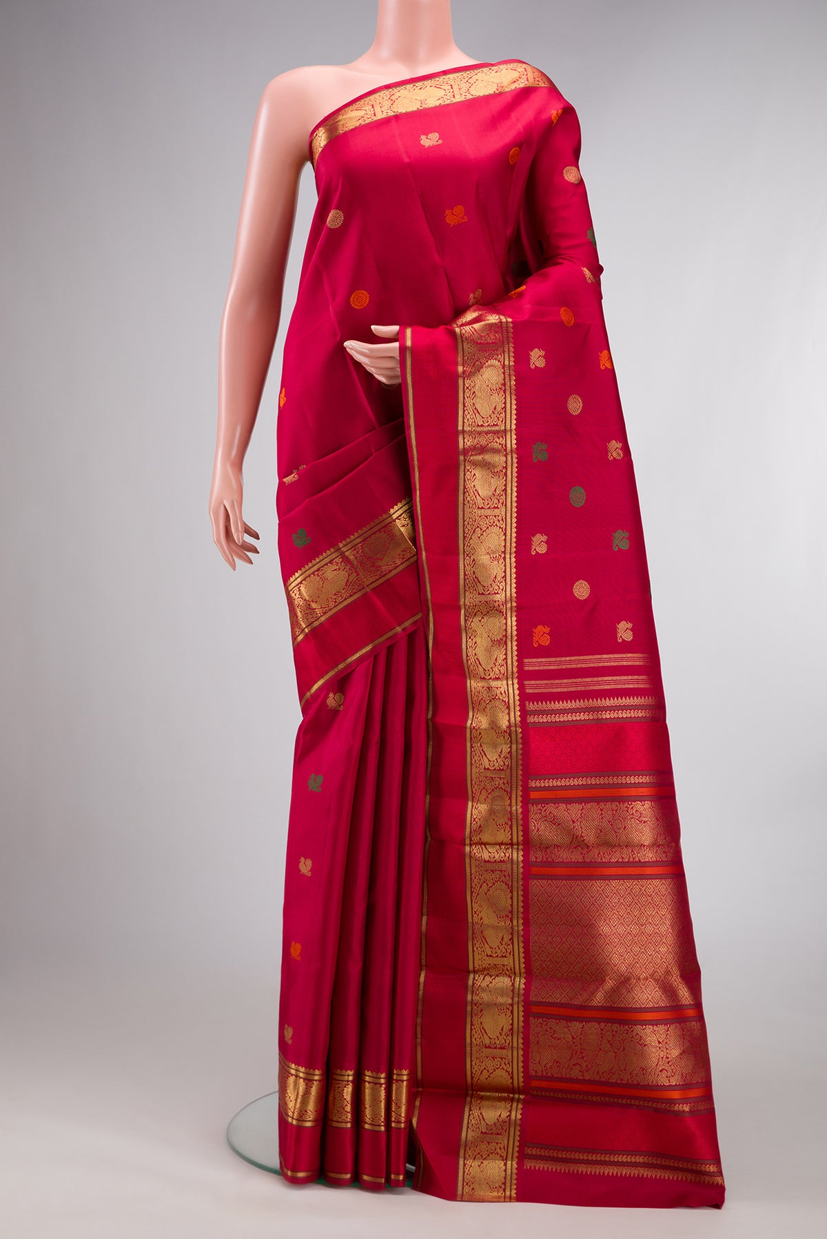 Pure Silk Pure Zari Deep Red Kanjivaram Saree with Zari And Thread Butta on the body and Zari Border.  displayed on a mannequin
