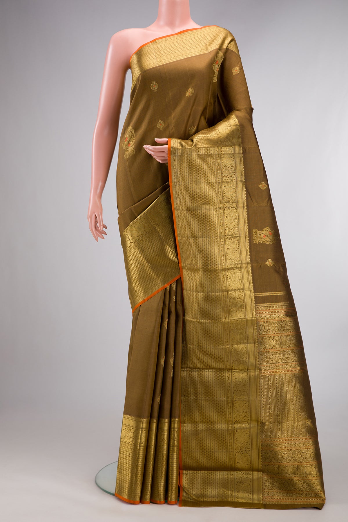 Pure Silk Pure Zari Mehandi Green Kanjivaram Saree with Zari Butta on the body and Zari Border.  displayed on a mannequin