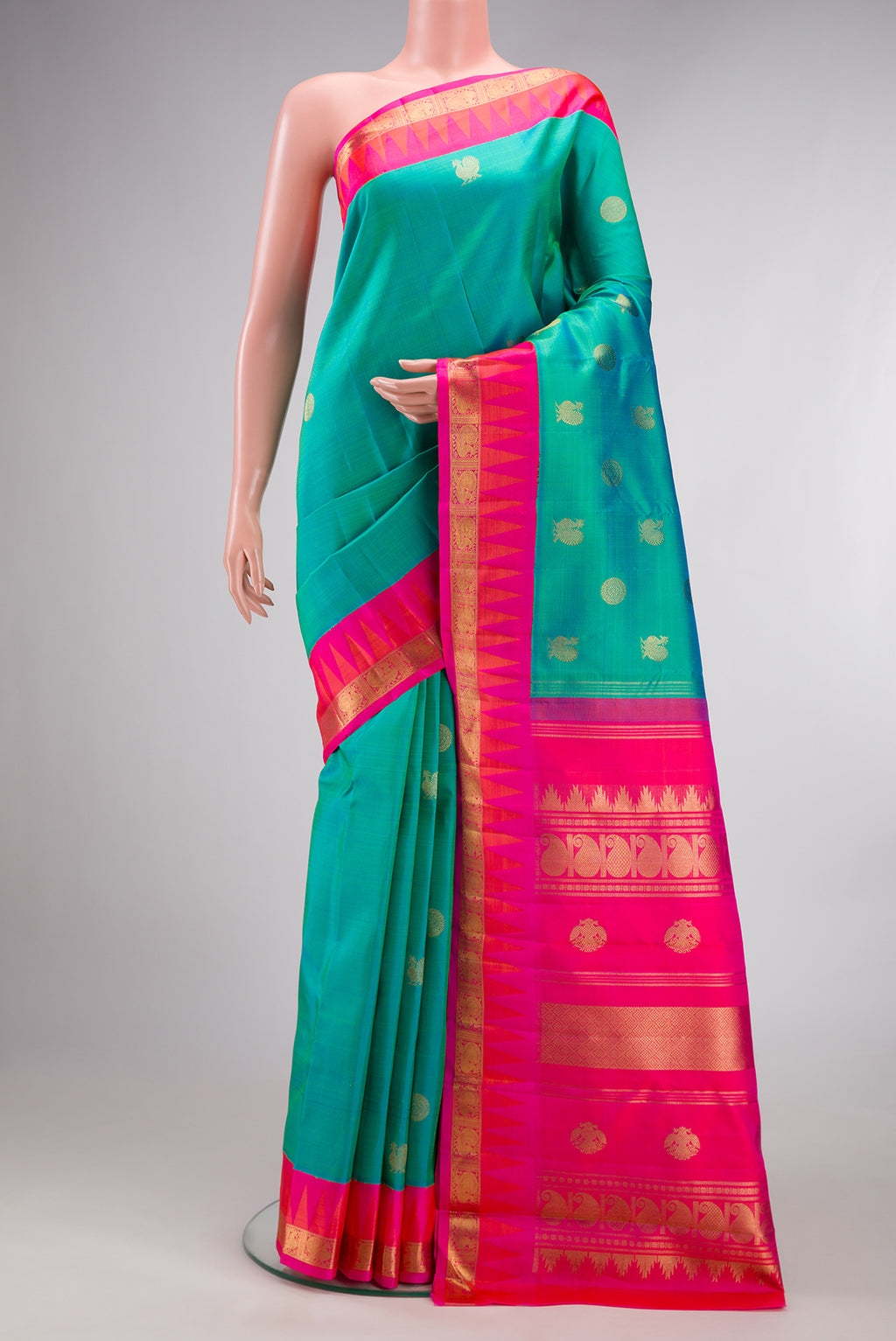 Pure Silk Pure Zari Sea Green Kanjivaram Saree with Zari Butta on the body and Temple Border.  displayed on a mannequin