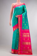 Pure Silk Pure Zari Sea Green Kanjivaram Saree with Zari Butta on the body and Temple Border.  displayed on a mannequin