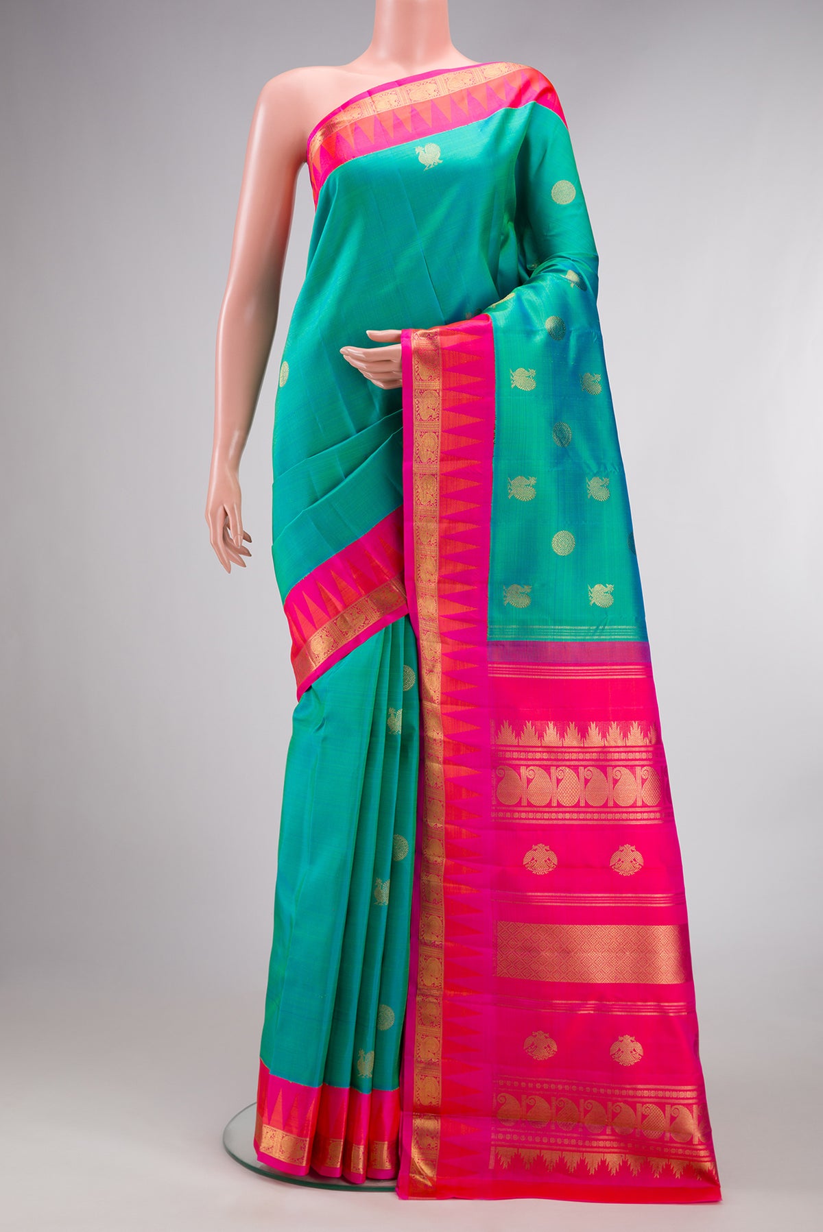 Pure Silk Pure Zari Sea Green Kanjivaram Saree with Zari Butta on the body and Temple Border.  displayed on a mannequin