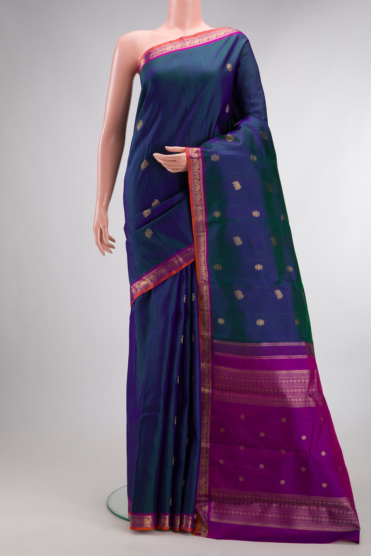 Pure Silk Pure Zari Peacock Blue Dual Tone Kanchipuram Saree with Zari Butta on the body and Zari Border.  displayed on a mannequin
