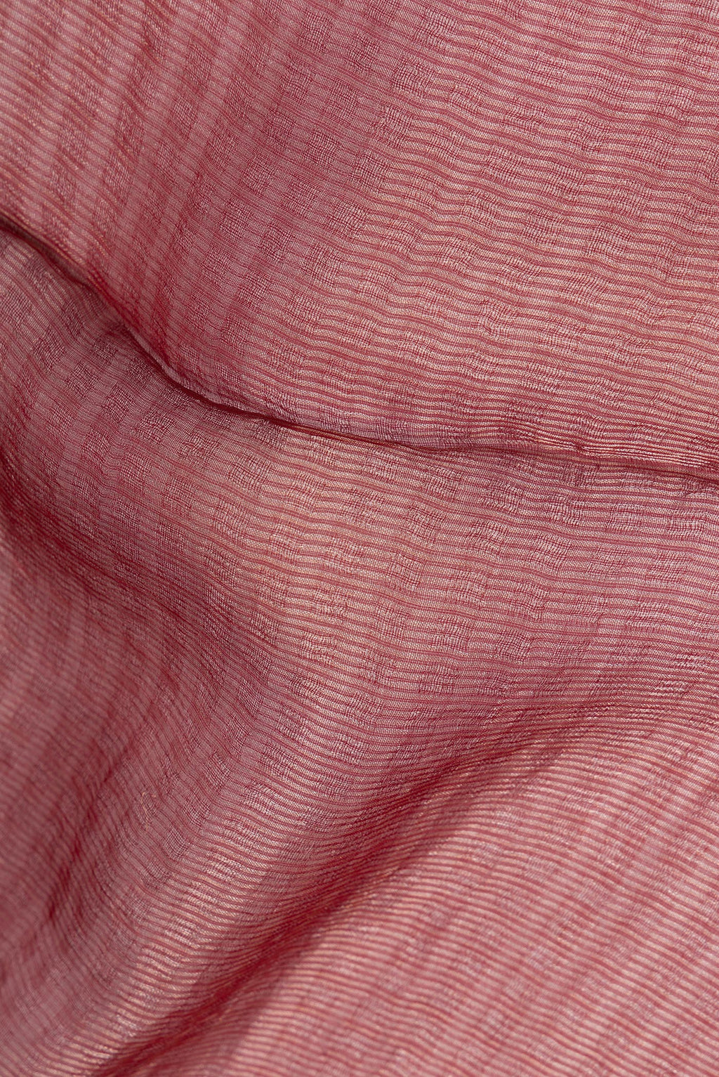 Close up of Rust Tussar Saree with Stripes on the body and Sequin Border.  displaying folds