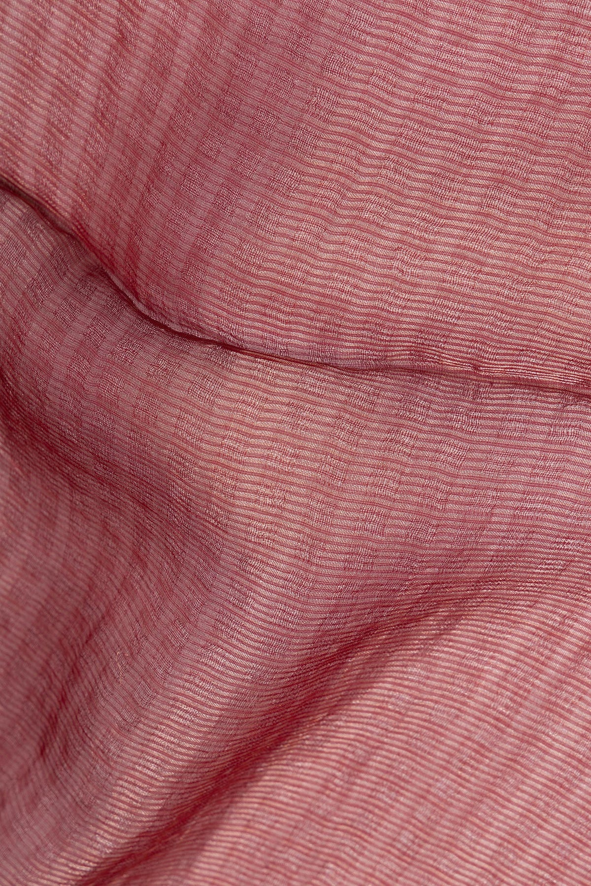 Close up of Rust Tussar Saree with Stripes on the body and Sequin Border.  displaying folds