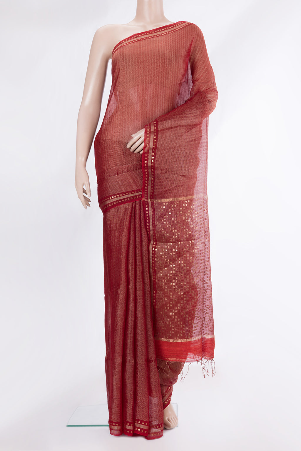 Rust Tussar Saree with Stripes on the body and Sequin Border.  displayed on a mannequin